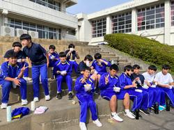 校舎前の階段に座り、カレーライスを食べている生徒たちの写真