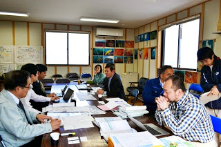 戸倉出張所の室内で関係者の方が資料を見ながら会議をしている写真