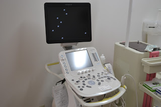 大きいモニターの下に、小さな画面とたくさんのボタンがついた白い操作盤があるエコーの機械の写真