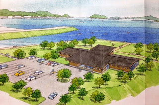 海に面した緑地と建物、駐車場が描かれた新しい施設の完成予想図のイラスト写真