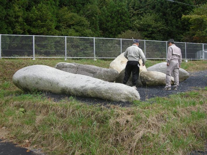 地面に大きく白っぽい花崗岩が横たわっているなまこ石の写真