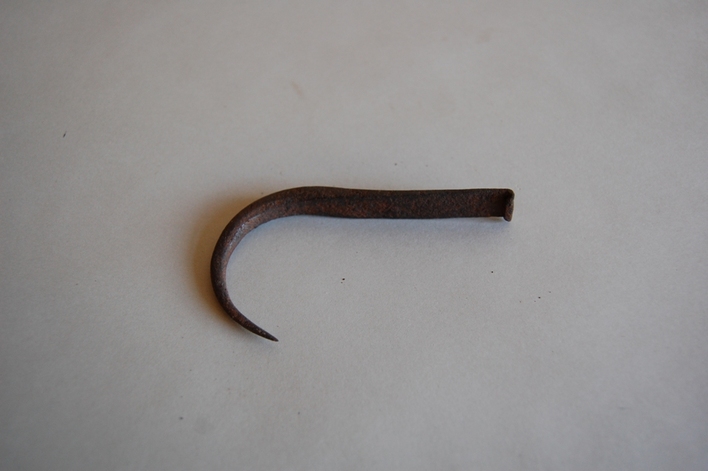 短く湾曲した先端を持つ鉄製の錆びたかぎ状のアワビかぎの写真