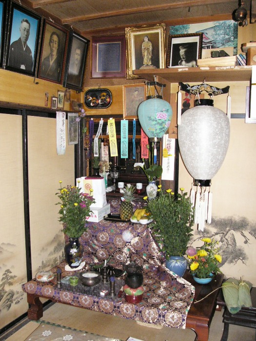 和室の一角に先祖の写真や位牌、供物、花、盆提灯が並べられた仏壇が設けられている盆棚を写した写真