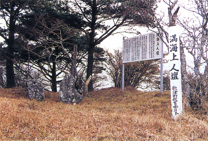 「満海上人壇」と書かれた標柱と説明書きが記載された看板のそばに立てられた石碑の写真