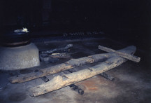 薄暗い室内に置かれた木製の二股に分かれた大型の橇の写真