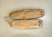 横長の木製に両端に紐を通す2つの穴があけられた「あば」の写真