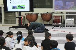 熊に遭遇した時の身の守り方について実演する役場職員の様子
