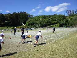 50m走に取り組む児童とスタートのお手伝いをする南三陸高校の生徒