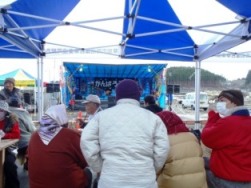 ステージ前に設置された休憩スペースに多くの来場者が集まっている様子を写した写真