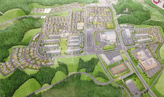 区画や道路が整然と描かれている、住宅、病院、ケアセンターなどが配置された完成後の街並みのイメージ図の写真