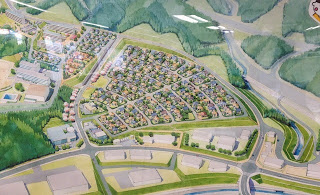 周囲を山に囲まれ、扇形に区画された区域に住宅地が整然と並んでいる様子が色鮮やかに描かれた完成イメージの写真