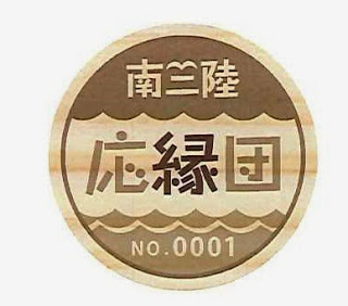 「南三陸応縁団」の文字と「NO.0001」が刻印された丸い木製の団員証の写真