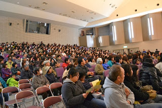 広いホールにぎっしりと観客が座っている会場内を写した写真