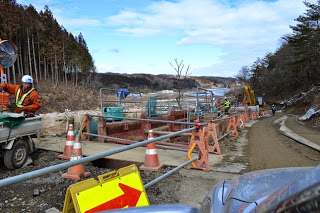 道路を封鎖して矢印の方向にしか通れないようにしている工事現場の写真