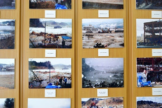 津波による被害と復旧作業の様子が写っている複数の写真の展示の様子を写した写真