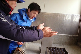 カキ加工施設の調査を行っている男性2名の写真